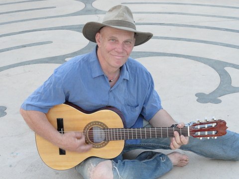 Geof Bard playing guitar outdoors